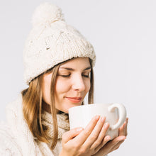 Warm winter cap with black knitted exterior and fur lining